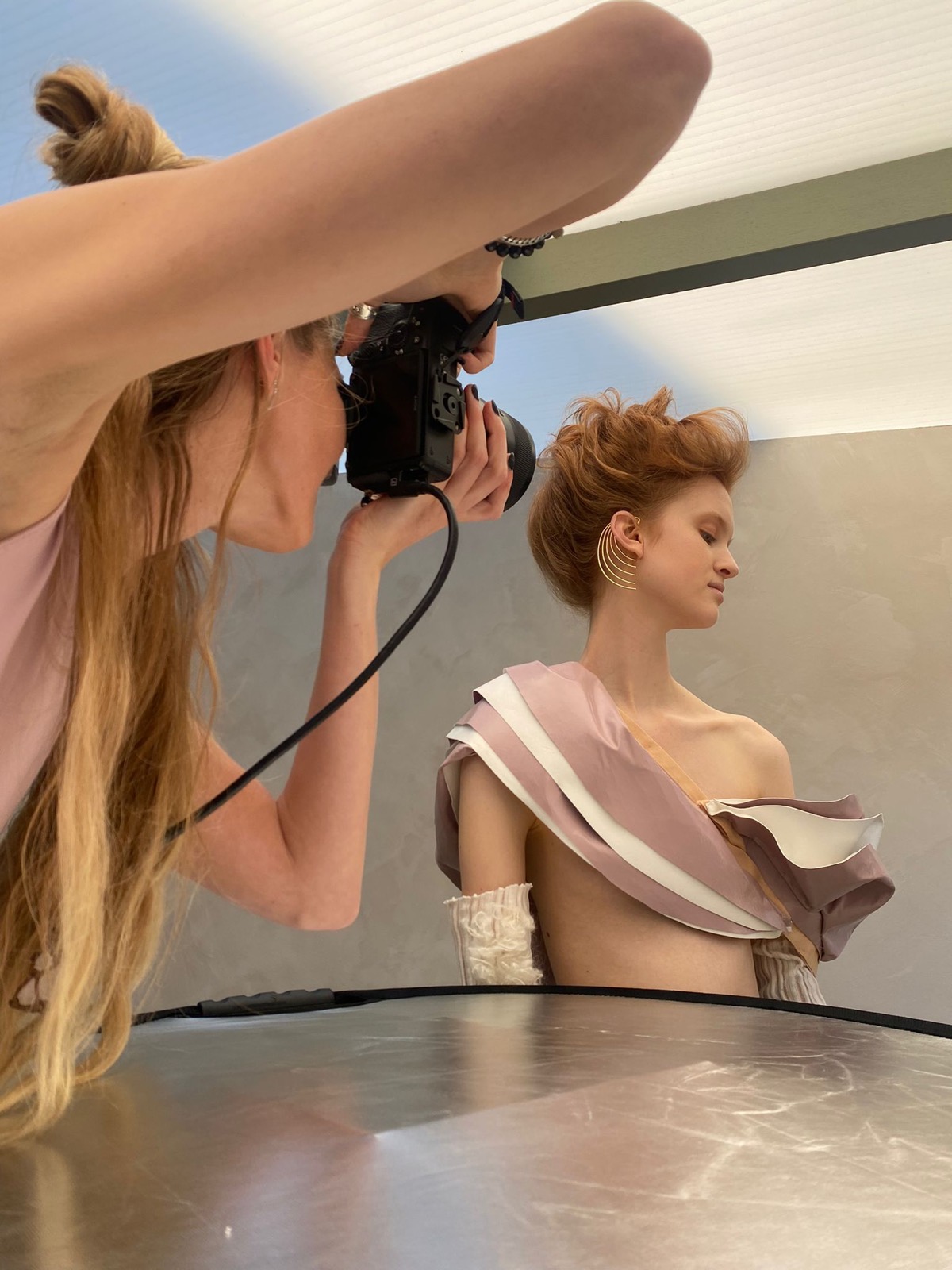 Zilla van den Born photographing a model in the studio